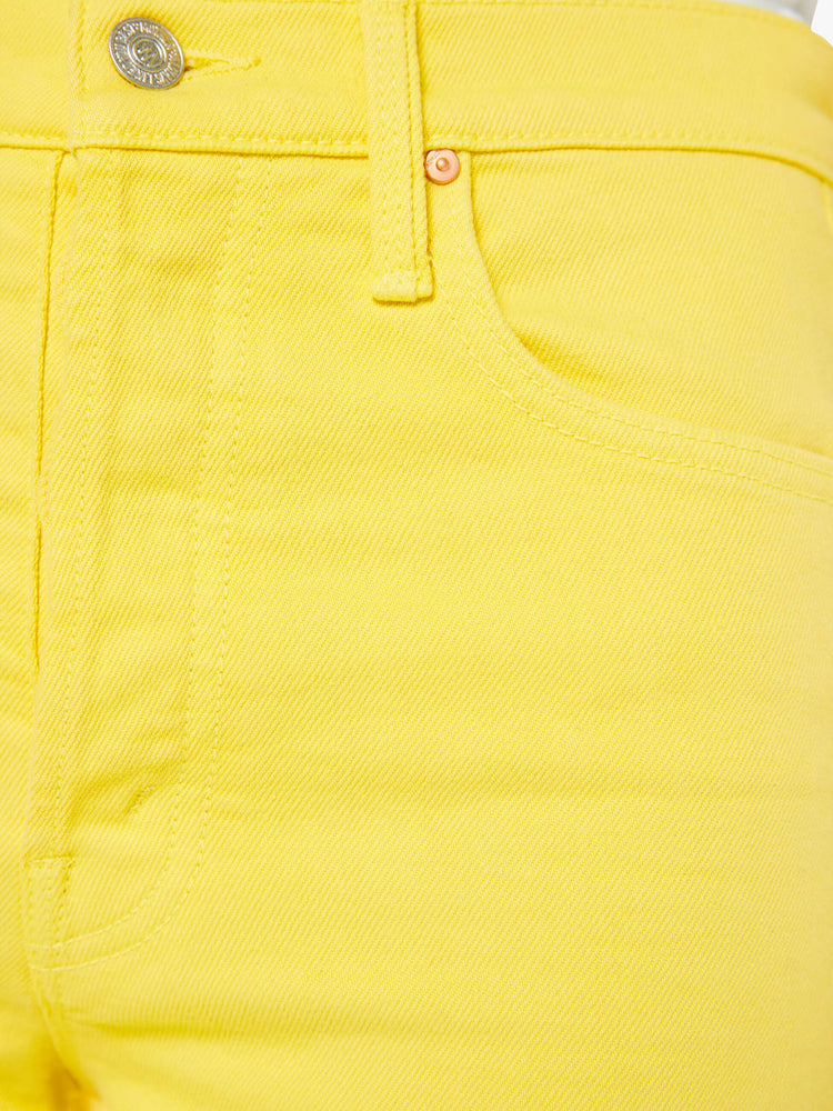 Swatch view of a woman in yellow high-waisted wide-leg jeans with a button fly, 31-inch inseam and a frayed hem.