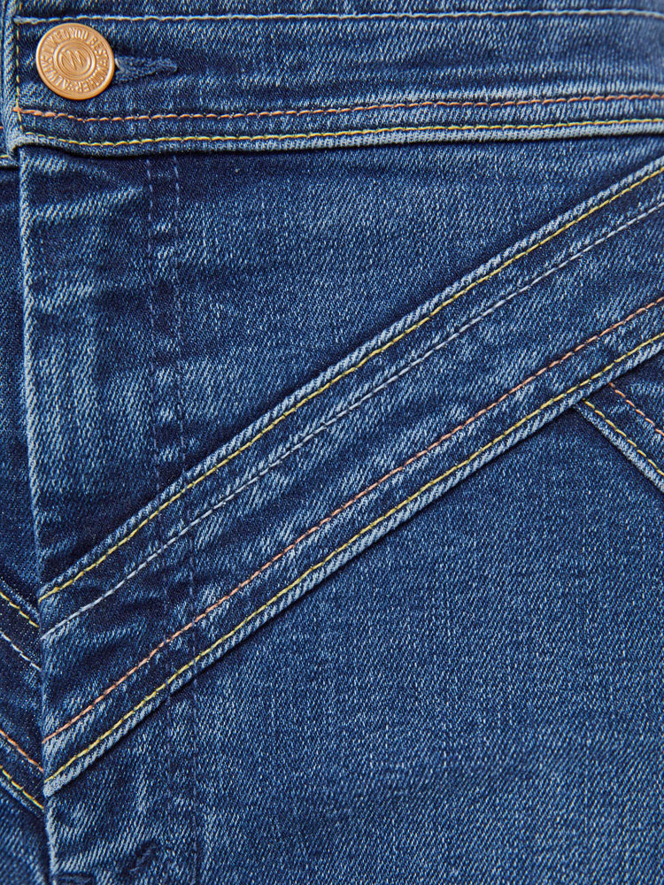 Swatch view of a woman in a mid blue high-rise wide-leg pants with a zip fly, seamed details on the waist, slit pockets and a long 34-inch inseam with a clean hem. 