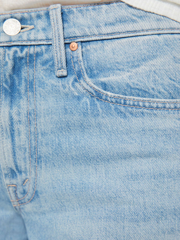 Swatch view of a woman in a light blue mid-rise wide-leg jeans with a zip fly, long 32-inch inseam and a clean, wide hem.