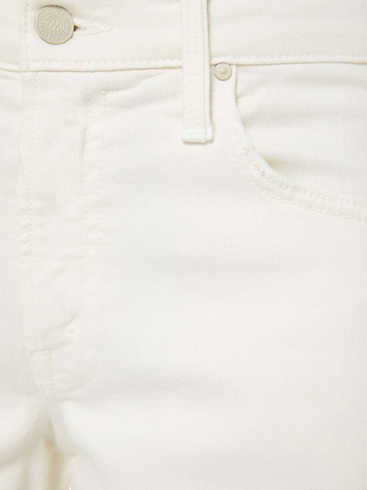 Swatch view of a woman in an off white mid-rise wide-leg jeans with a zip fly, long 32-inch inseam and a clean, wide hem.