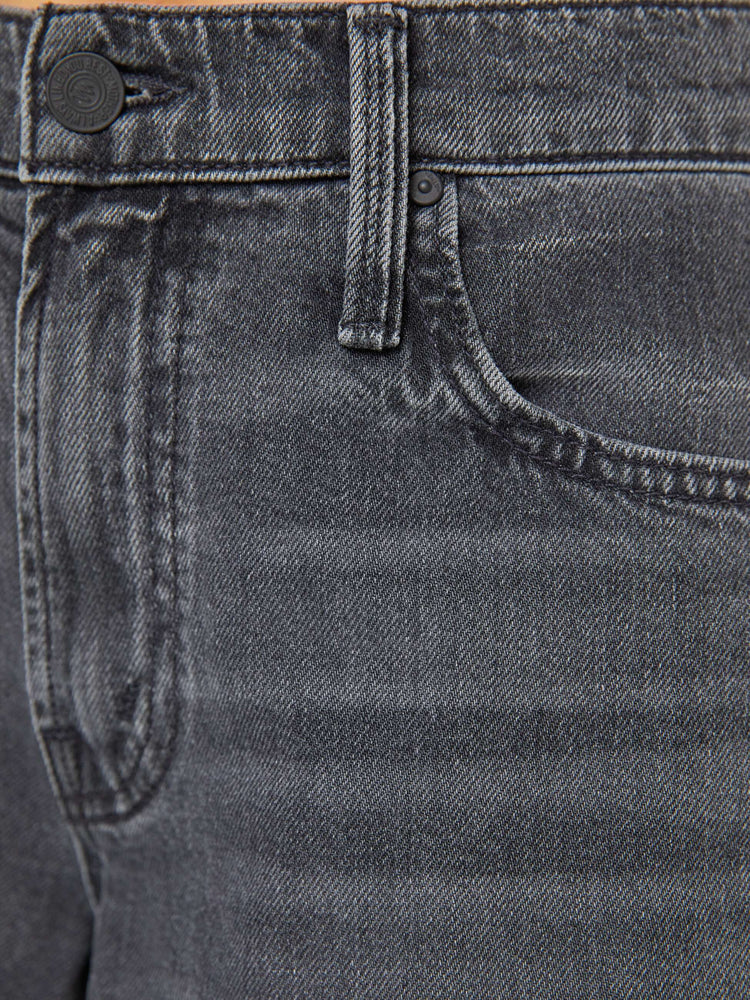 Swatch view of a woman in a faded black mid-rise wide-leg jeans with a zip fly, long 34-inch inseam and a clean, wide hem.