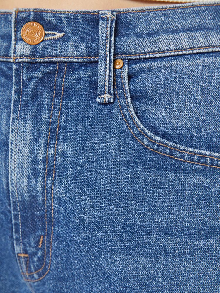 Swatch view of a woman in med blue wide-leg pants with a zip fly, mid rise and a long 34-inch inseam with a clean hem.