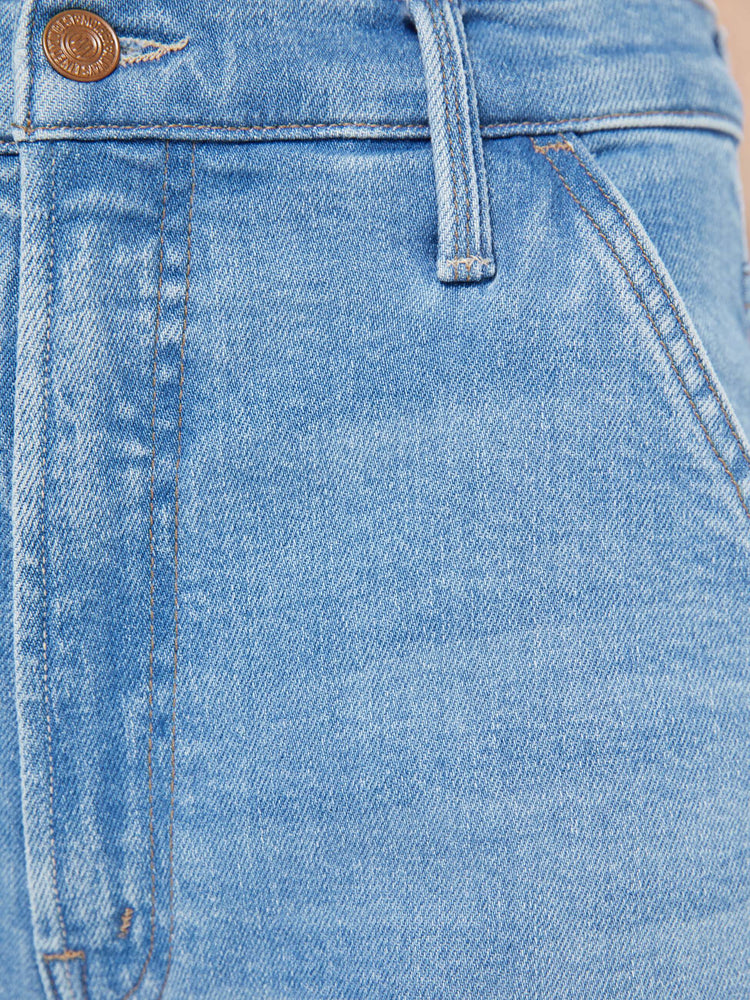 Swatch view of a woman in a light blue super high-waisted pants with a loose, straight leg, zip fly, utility-inspired patch pockets, hammer loop and an ankle-length inseam with a clean hem.