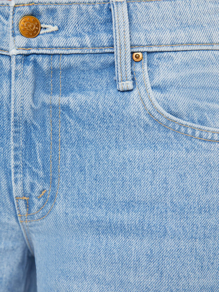 Swatch view of a woman in a light blue mid-rise jeans have a long 32-inch inseam and a clean hem.