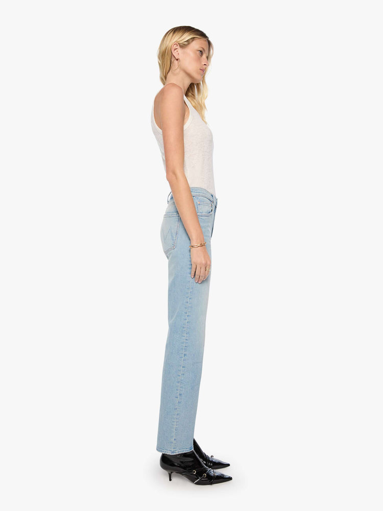 Side view of a woman in a light blue mid-rise straight-leg pants with a zip fly, long 32-inch inseam and a clean hem.