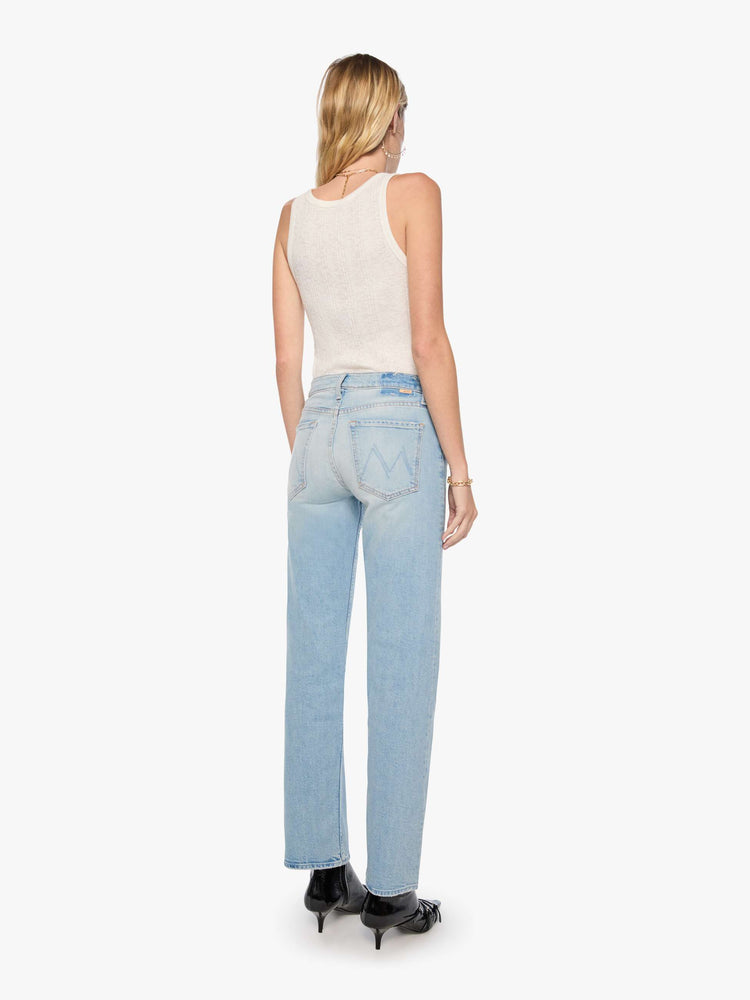 Back view of a woman in a light blue mid-rise straight-leg pants with a zip fly, long 32-inch inseam and a clean hem.