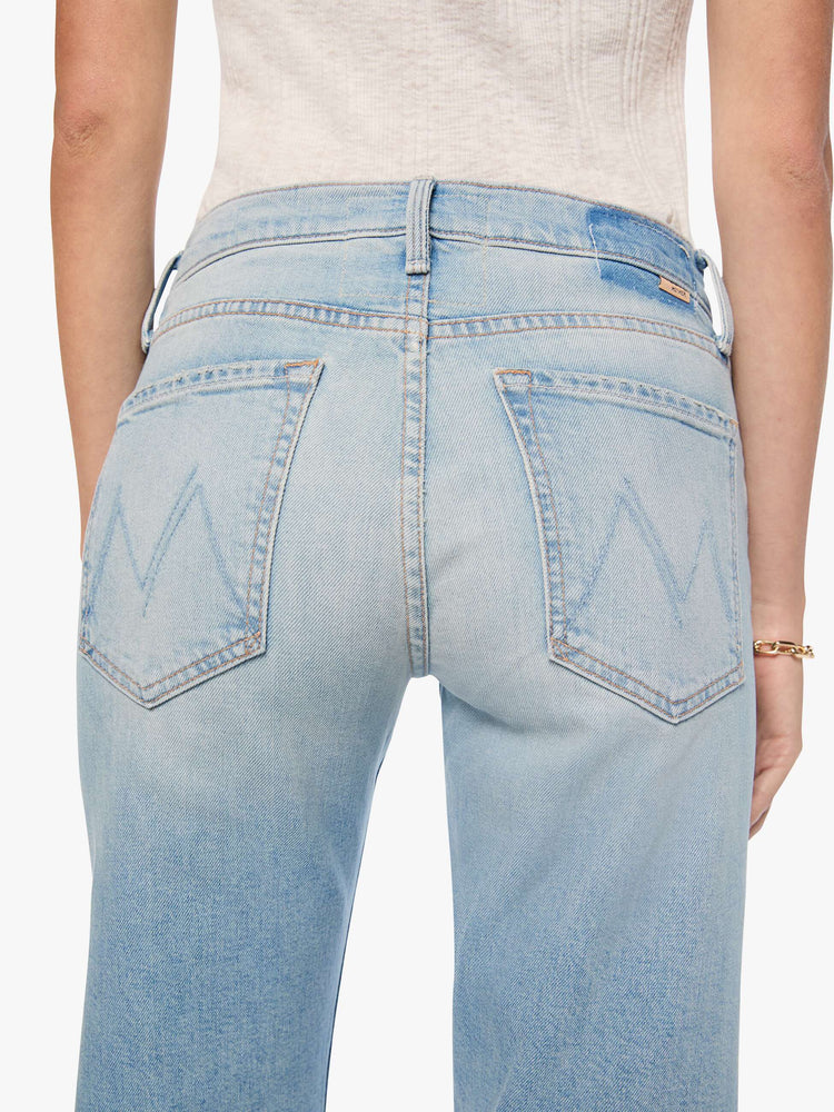 Close up view of a woman in a light blue mid-rise straight-leg pants with a zip fly, long 32-inch inseam and a clean hem.