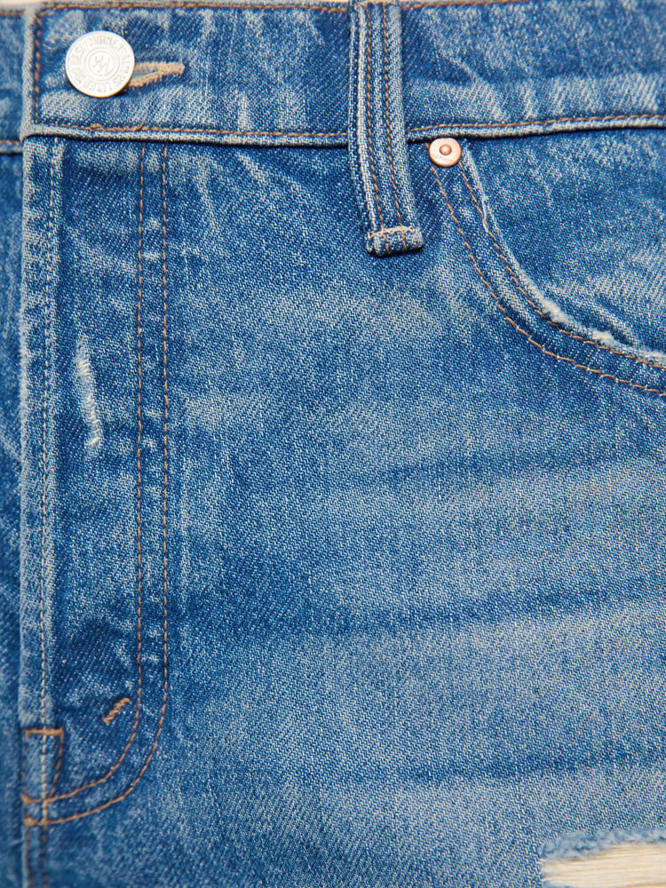 Swatch view of a woman in a med blue with tears in the knees high-waisted wide leg jeans with a button fly, 32-inch inseam and loose, low-slung fit. 