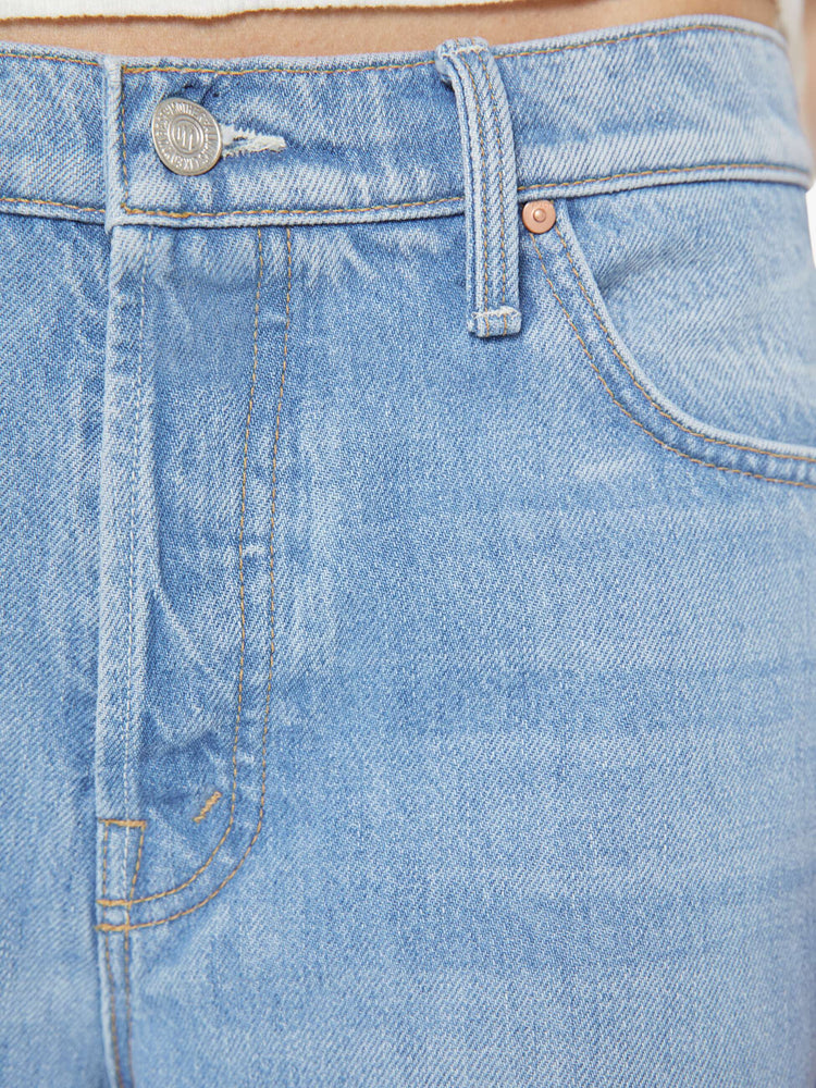 Swatch view of a woman in a light blue high-waisted wide leg jeans with a zip fly, a long 32-inch inseam and loose, low-slung fit.