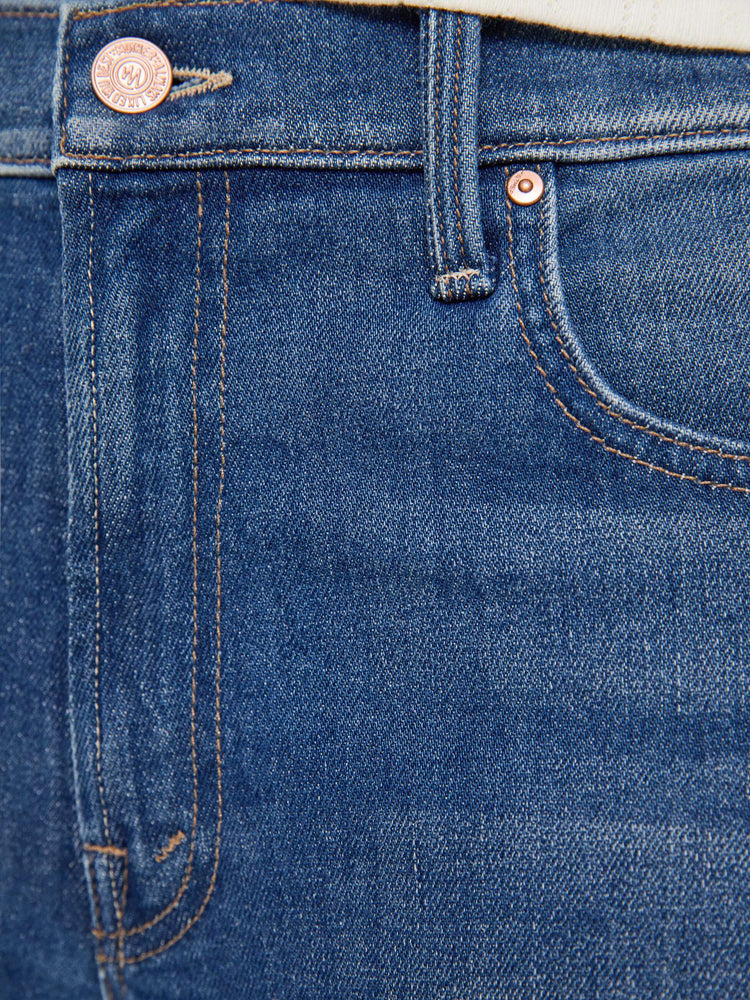 Swatch view of a woman in a mid blue high-waisted wide leg jeans with a zip fly, 33-inch inseam and loose, low-slung fit.