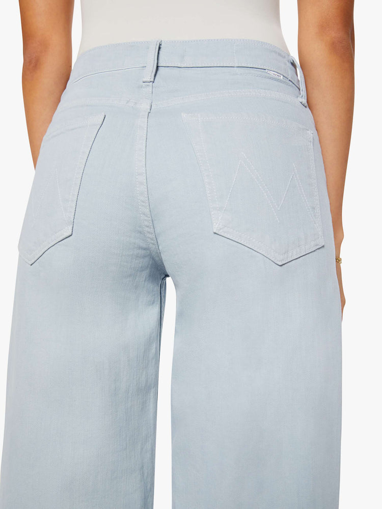 Back close up view of a woman in a light blue high-waisted wide leg jeans with a zip fly, long 33 1/4-inch inseam and loose, low-slung fit.
