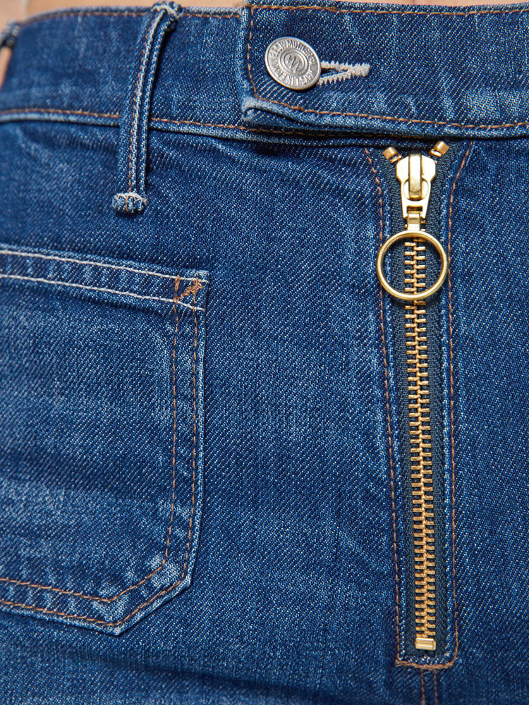 Swatch view of a woman in a dark blue wide leg jeans with a high rise, exposed zip fly, tabbed waistband, patch pockets and a long 34-inch inseam with a clean hem.