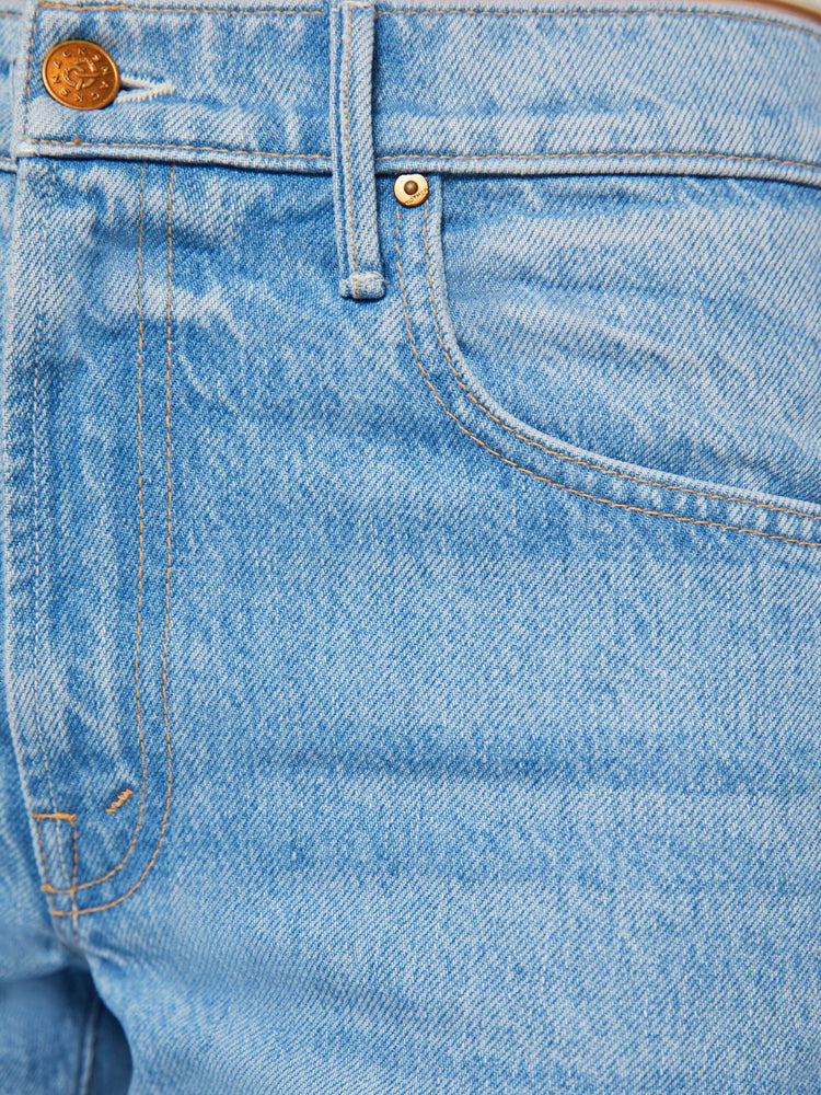 Swatch view of a woman in a light blue high-waisted jeans are designed with a zip fly, relaxed fit and a 31-inch inseam with a clean hem.