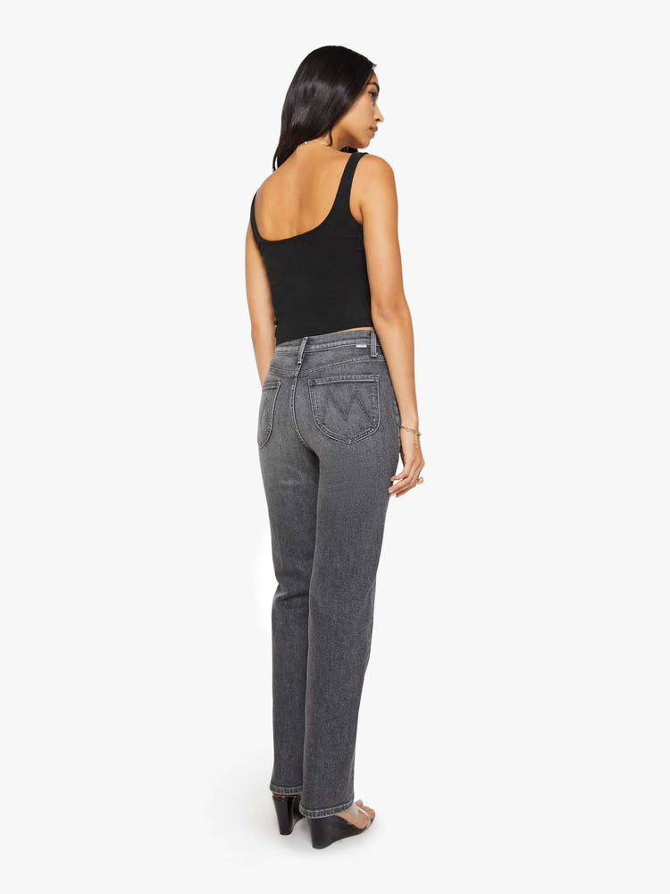 Back view of a woman in a dark grey high-rise jeans with a straight leg, zip fly, curved patch pockets with slit openings and a 32-inch inseam with a clean hem.
