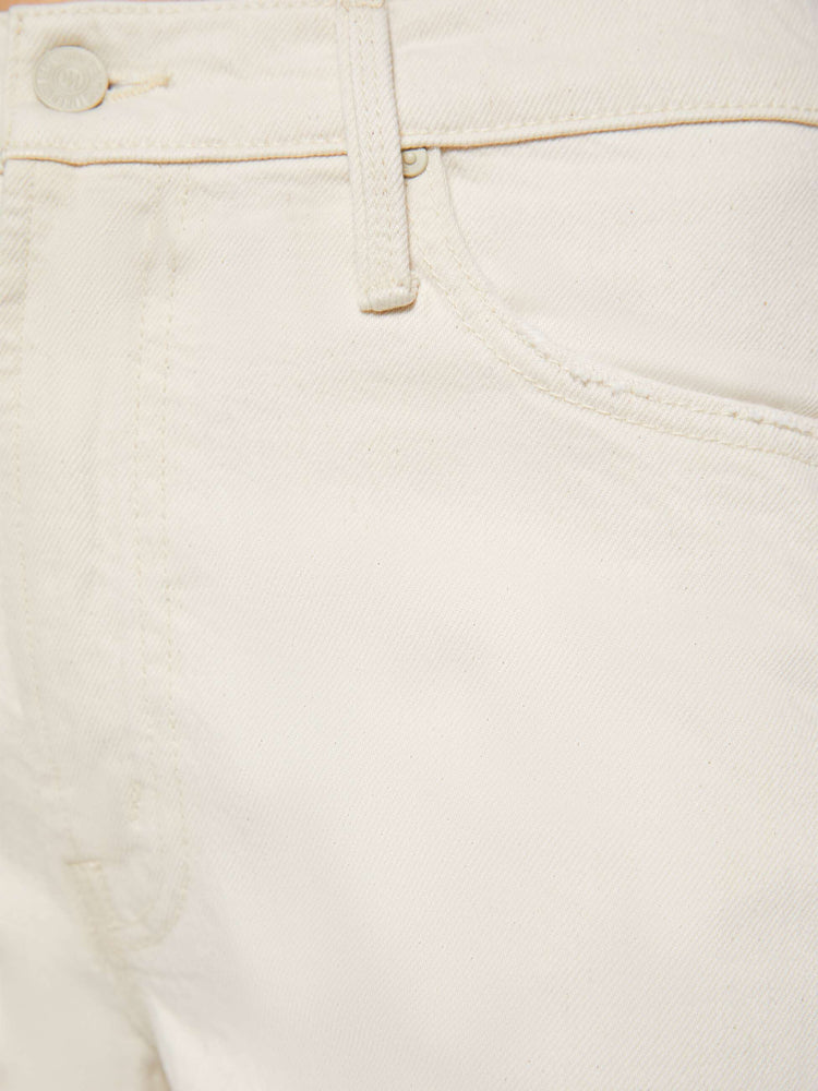Swatch view of a woman in creamy white pants designed to sit lower on the hips with a zip fly, loose straight leg and a clean 31-inch inseam.