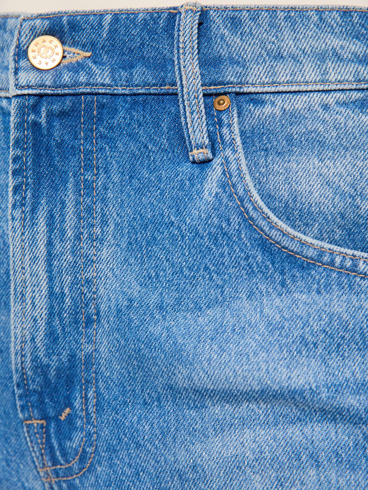Swatch view of mid blue high-waisted jeans have a loose, low-slung fit, zip fly, a white stripe down the outer seam with adjustable snaps, a long 31-inch inseam and a clean hem.