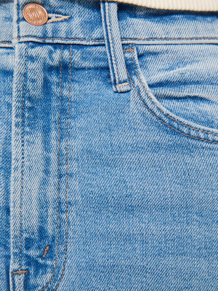 Swatch view of a woman in a light blue wide leg jeans with a high rise, 32-inch inseam and a clean hem.