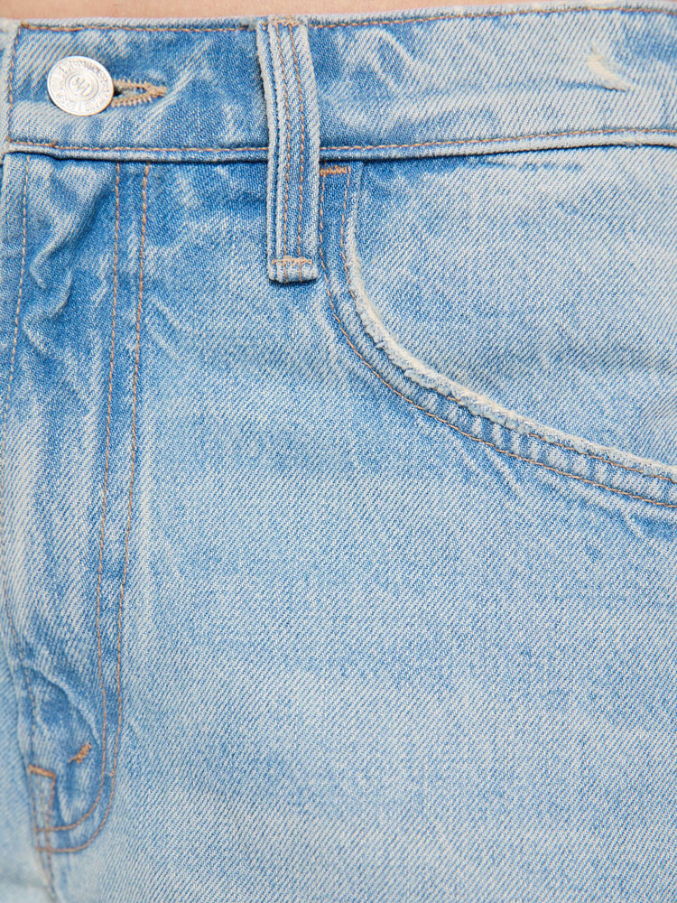 Swatch view of a woman in a light blue jeans designed to sit lower on the hips with an ankle-length inseam, zip fly, tacked, folded hem and a slightly tapered leg. 