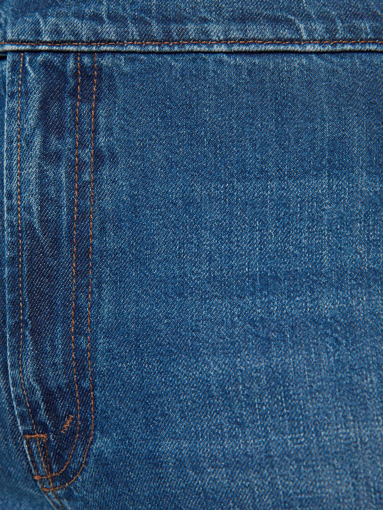 Swatch view of a woman in med blue high-rise wide-leg jeans with a zip fly, button-tab waistband, a long 32-inch inseam and a loose, low-slung fit. 