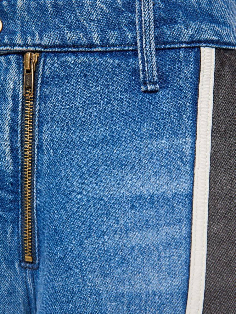 Swatch view of a woman in mid blue with moto-inspired panels in faded black with white trim at the hips wide-leg jeans are designed with an exposed zip fly, button-tab waistband, side slit pockets, a zipper down the outer calf seam and a long 32-inch inseam with a clean hem.