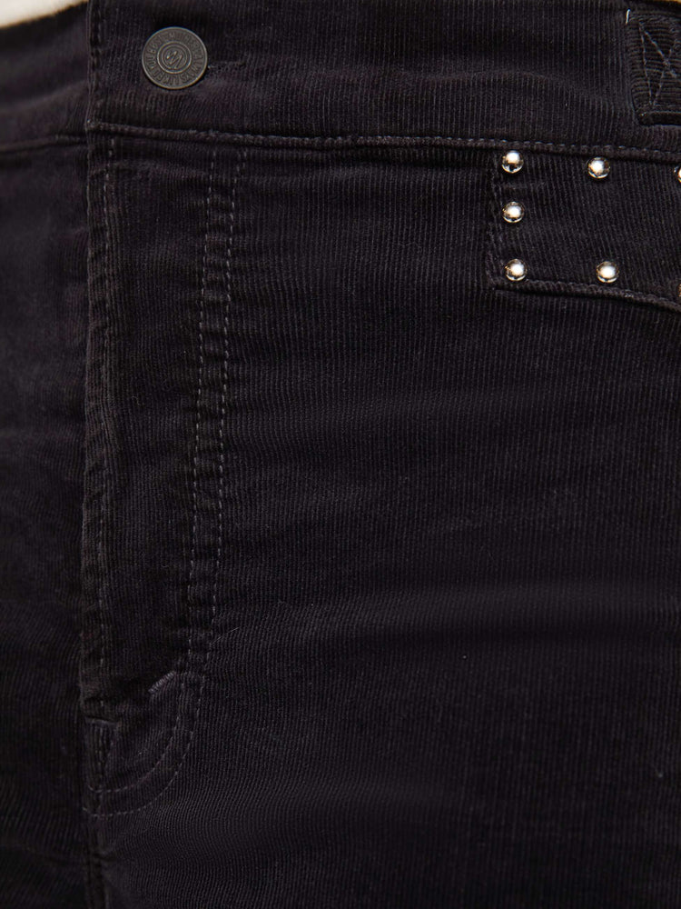 Swatch view of a woman in a black corduroy high-waisted wide-leg pants with a button fly, adjustable details at the waistband, a 31-inch inseam and clean hem.