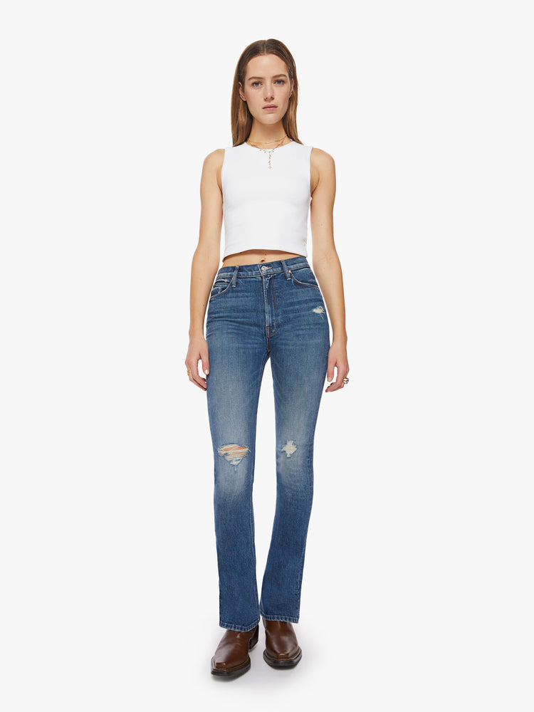 Front view of a classic skinny flare with a high rise and a full-length inseam with a sliced hem in a dark blue wash.