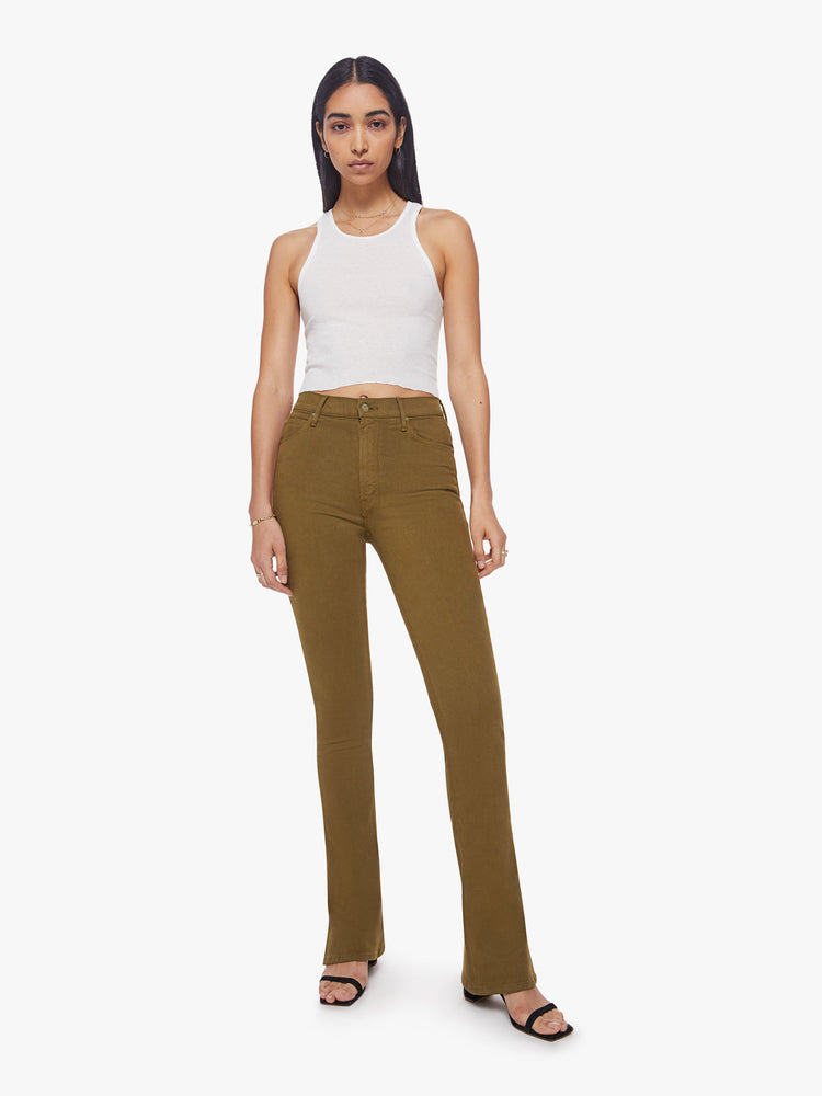 Front view of a woman skinny flare with a high rise and a full-length inseam with a sliced hem in a fir green hue.
