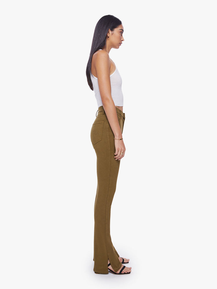 Side view of a woman skinny flare with a high rise and a full-length inseam with a sliced hem in a fir green hue.