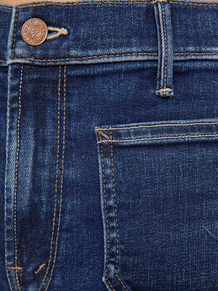 Swatch view of a woman in a dark blue mid-rise jeans with a loose fit, wide leg, patch pockets, zip fly and 32-inch inseam with a clean hem.