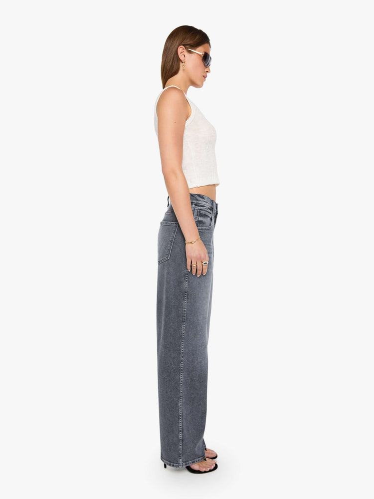 Side view of a grey washed jeans designed to sit lower on the hips with a zip fly, slightly tapered leg and a 31-inch inseam with a clean hem.