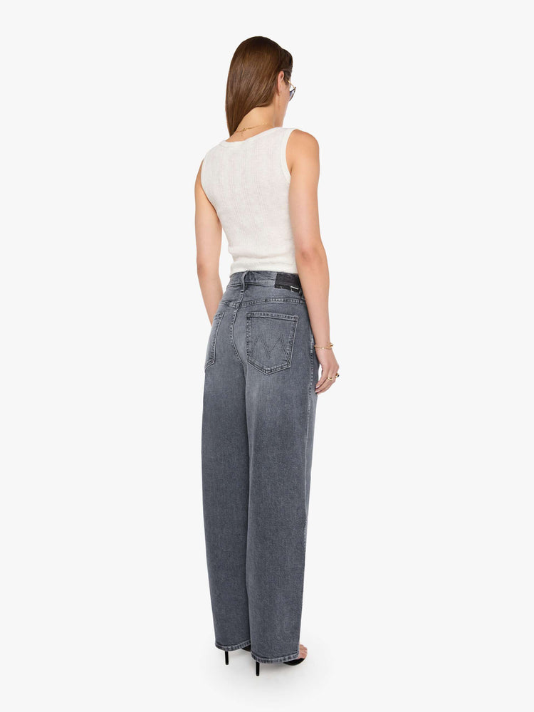 Back view of a grey washed jeans designed to sit lower on the hips with a zip fly, slightly tapered leg and a 31-inch inseam with a clean hem.