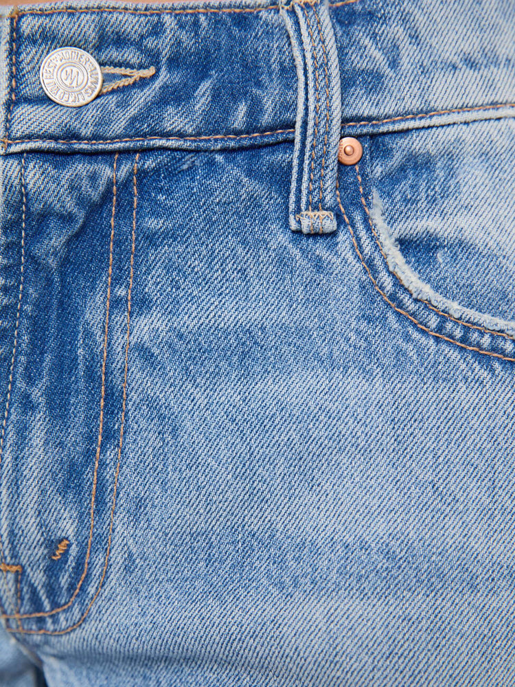 Swatch view of a woman in a med blue jeans designed to sit lower on the hips with a 32-inch inseam, zip fly, clean hem and slightly tapered leg.