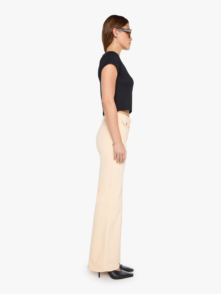 Side view of a peachy khaki wide leg jeans with a high rise, zip fly, button-tab waistband, miniature patch pockets, a 32-inch inseam and a clean hem.