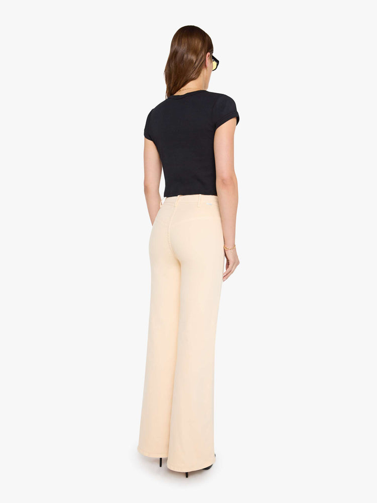 Back view of a peachy khaki wide leg jeans with a high rise, zip fly, button-tab waistband, miniature patch pockets, a 32-inch inseam and a clean hem.
