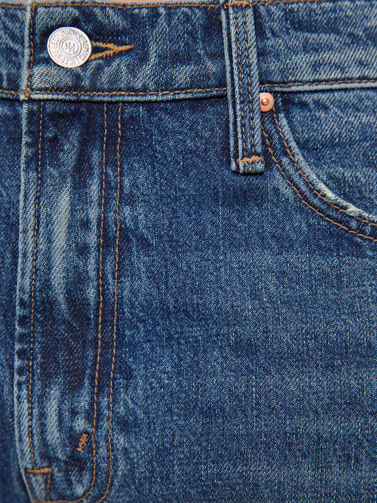 Swatch view of a woman in a med blue jeans designed to sit on the hips with a slouchy fit, a loose straight leg, zip fly and a 34-inch inseam with a clean hem. 