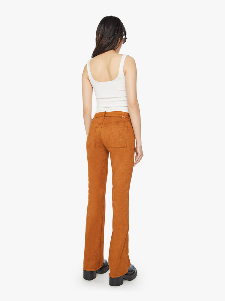 Back view of a woman mid-rise bootcut pants with front patch pockets, a long 34-inch inseam and a slightly slouchy fit in a light brown faux suede.