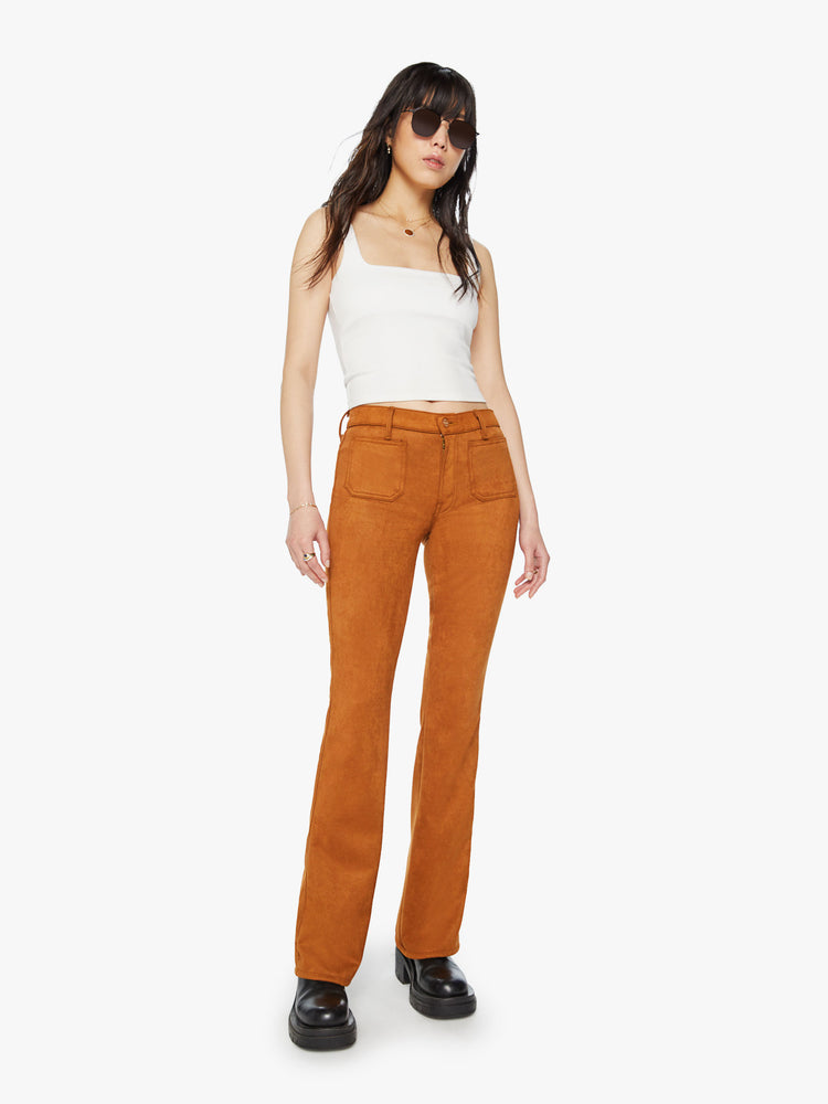 Front view of a woman mid-rise bootcut pants with front patch pockets, a long 34-inch inseam and a slightly slouchy fit in a light brown faux suede.