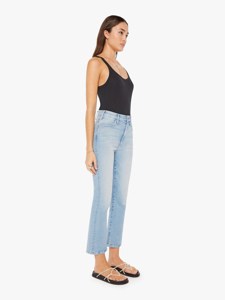 Front view of a womens light blue wash jean featuring a high rise and an ankle length flare with a clean hem.