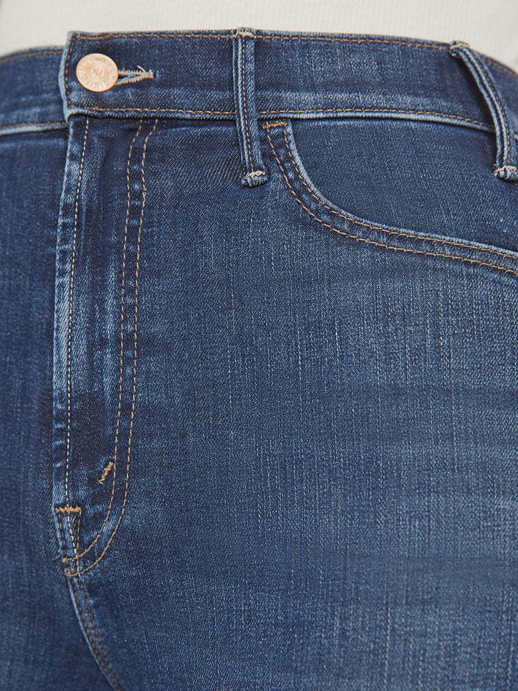 Swatch view of a woman high-rise flare has an ankle-length inseam and a clean hem in a dark blue wash.