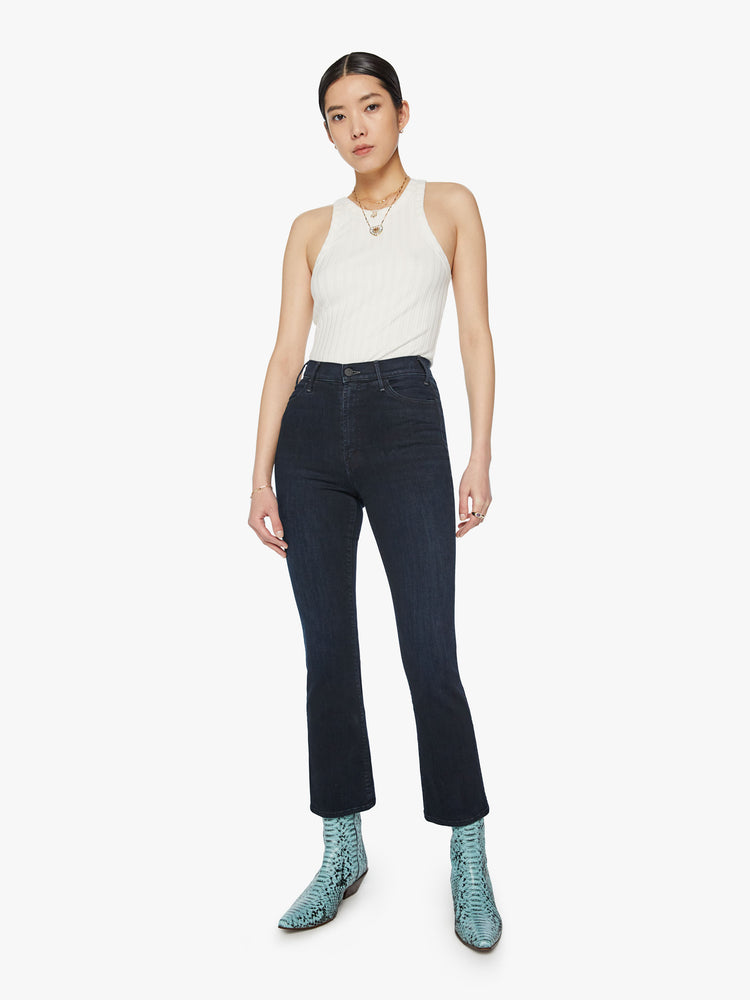Front view of a woman high-rise flare with an ankle-length inseam and a clean hem in dark blue wash.