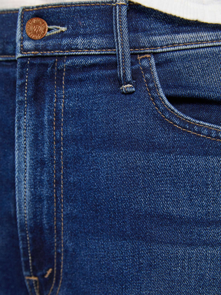 Swatch view of a woman in a dark blue high-rise flare jean with an ankle-length inseam and a clean hem.