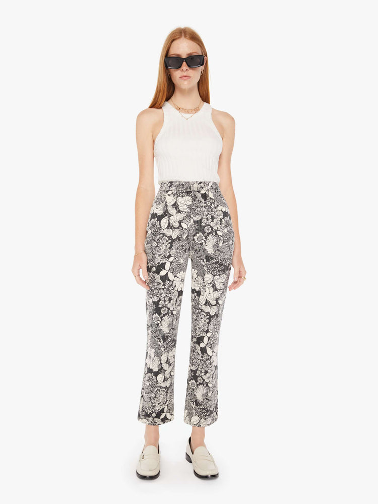 Front view of a womens high rise flare jean featuring an all over black and white print of flowers.