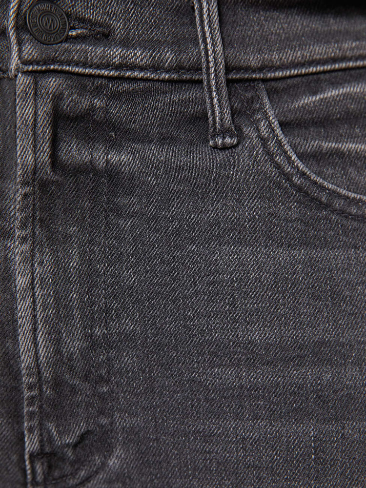 Swatch view of a woman in a faded grey high-rise flare has an ankle-length inseam and a clean hem.