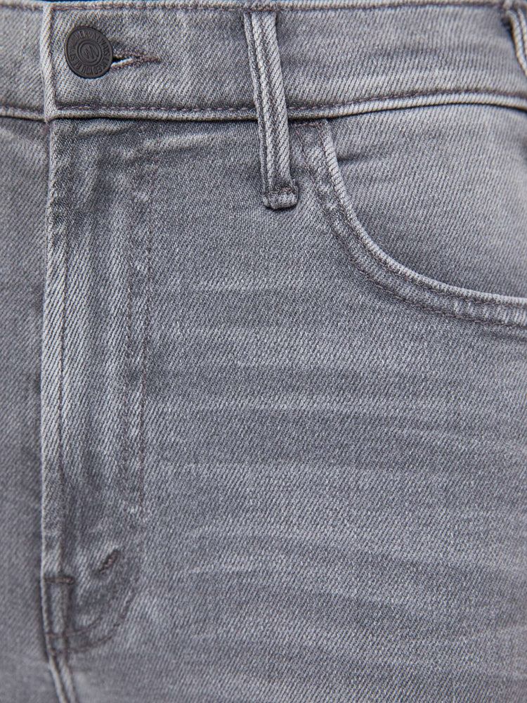 Swatch view of a woman in a grey high-rise flare has a zip fly, ankle-length inseam and a clean hem.