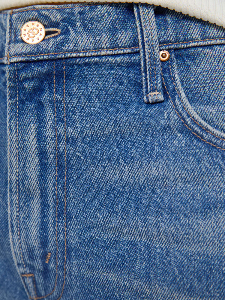 Swatch view of a woman in a wide-leg jeans are designed with a zip fly, low slung fit and a 28.25-inch inseam with a cuffed hem.