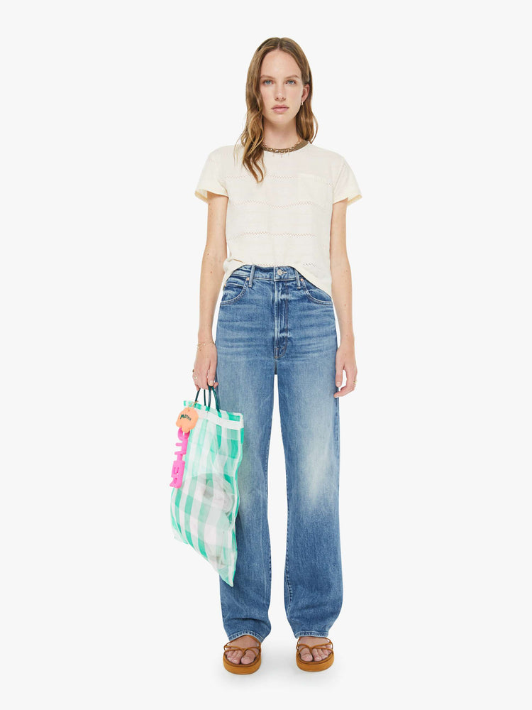 Front view of a woman in a med blue super high-waisted wide-leg jeans with a zip fly, long 32-inch inseam and a clean hem.