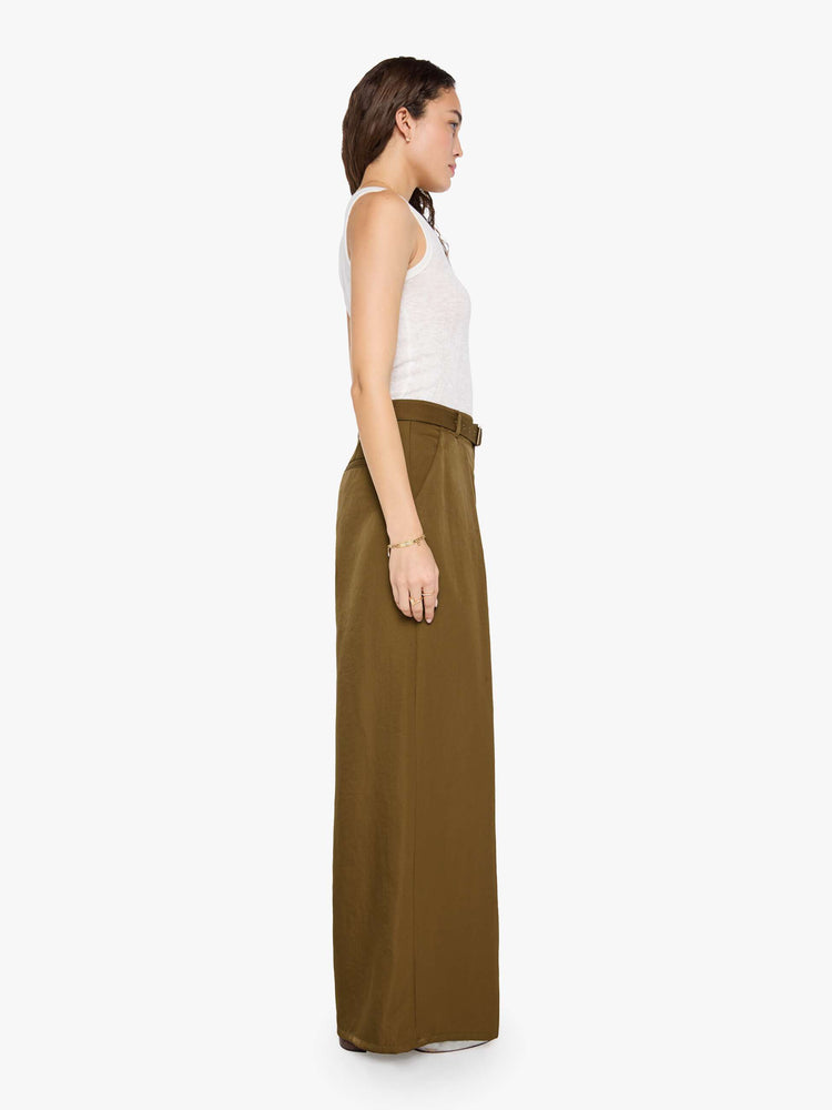 Side view of a woman in a bronze super high-waisted pants with a belted waistband, zip fly, curved leg, slit pockets, pleats for an even wider fit, and a long inseam with a clean hem.