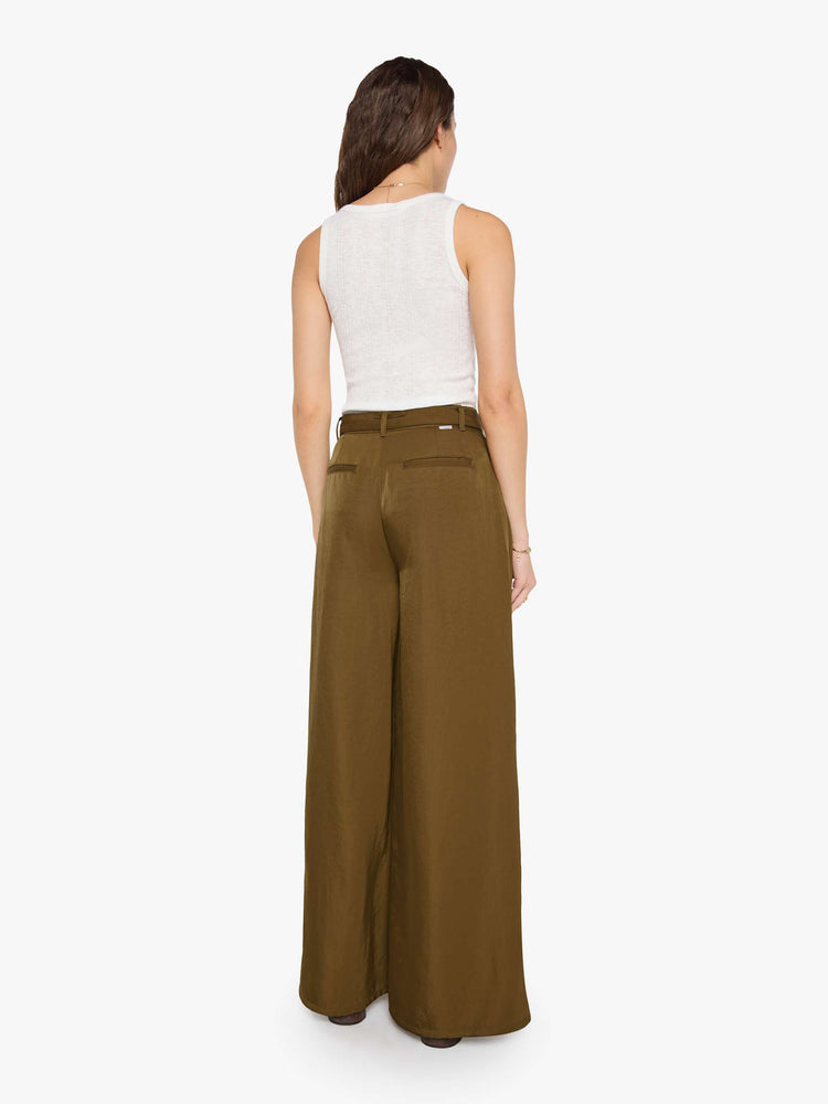 Back view of a woman in a bronze super high-waisted pants with a belted waistband, zip fly, curved leg, slit pockets, pleats for an even wider fit, and a long inseam with a clean hem.