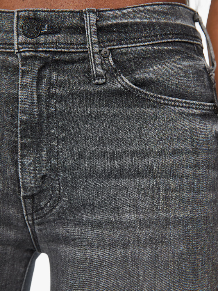 Swatch view of a woman mid-rise flare with a long 34-inch inseam and a clean hem in a faded black wash.