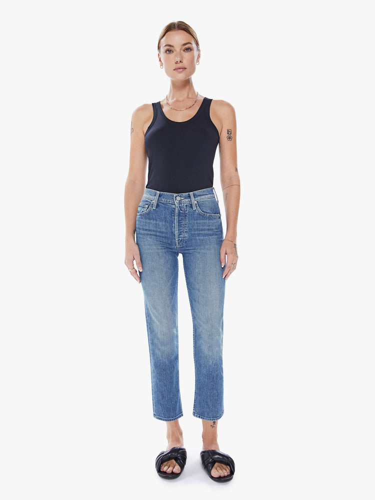 Front view of a womens medium blue wash jean featuring a high rise, straight leg, and a clean cropped hem.